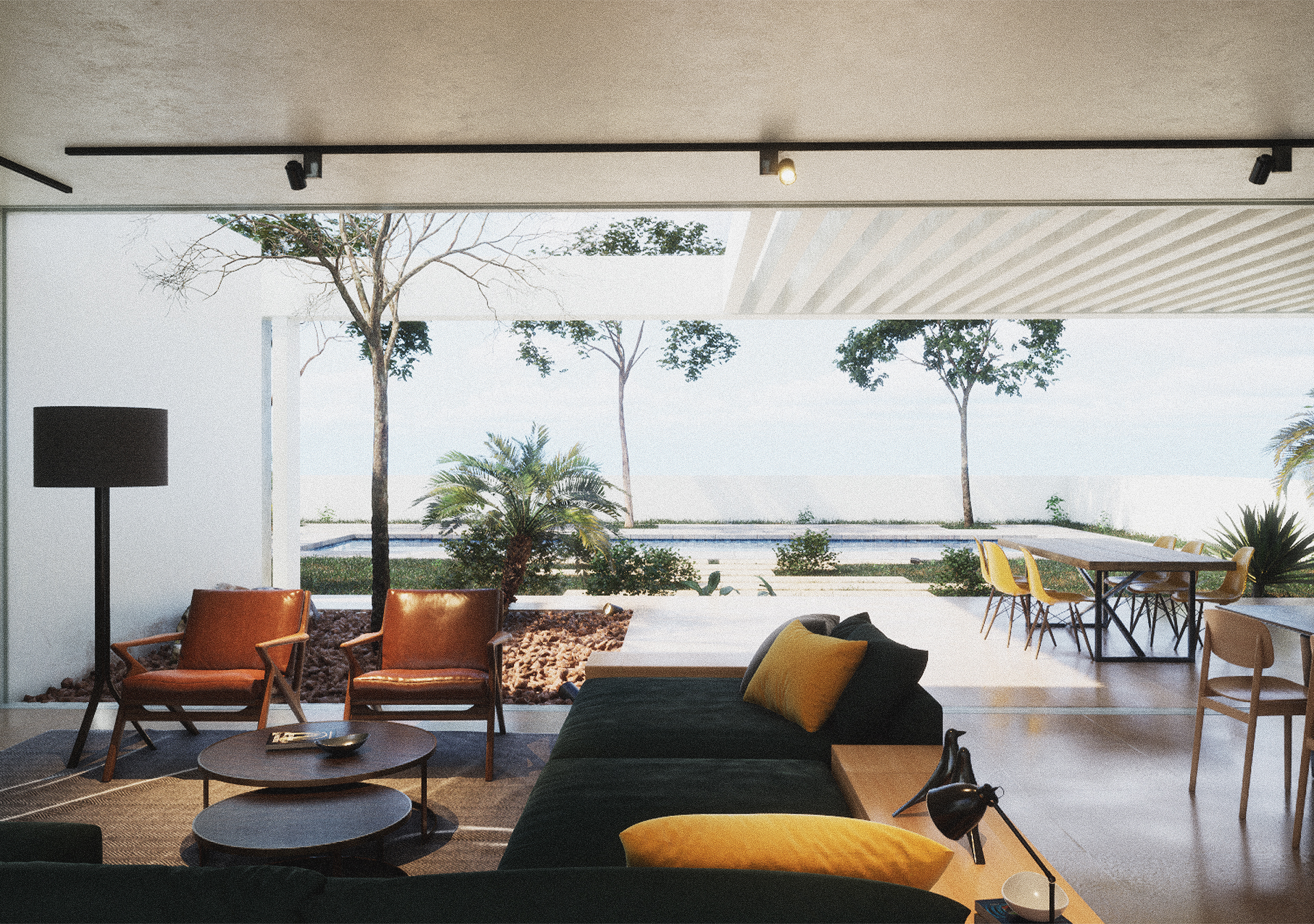 A wide-angle shot of a modern white villa featuring a large open-plan living area that flows onto a stone patio with a swimming pool and coastal vegetation.